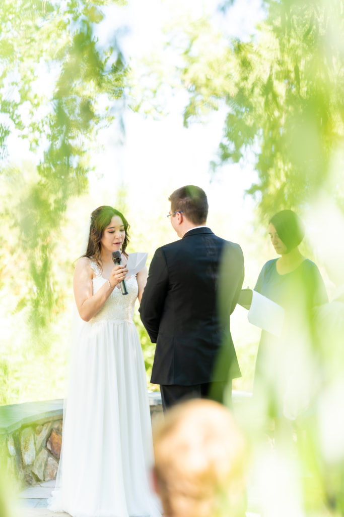 Ceremony of summer wedding at Hudson Gardens and Event Center in Littleton, Colorado.