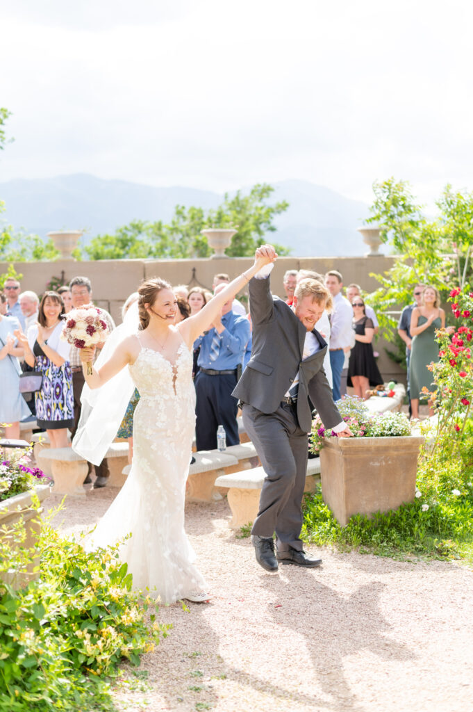 Bride and Groom celebrating after the wedding ceremony at Hillside Gardens and Event Center in Colorado Springs.