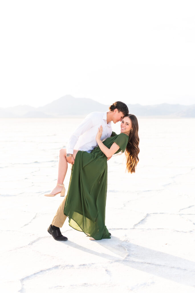 Groom dipping his bride for dip and kiss pose during Colorado engagement photoshoot