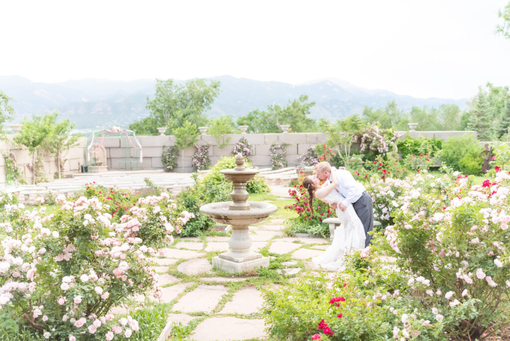 Bride and groom kissing at the gardens at hillside gardens and event center in Colorado Springs. 