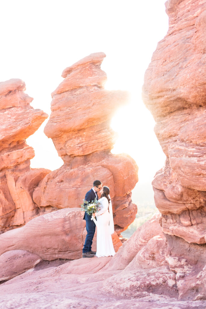 bride and groom intimately hugging one another at with red rock landscape