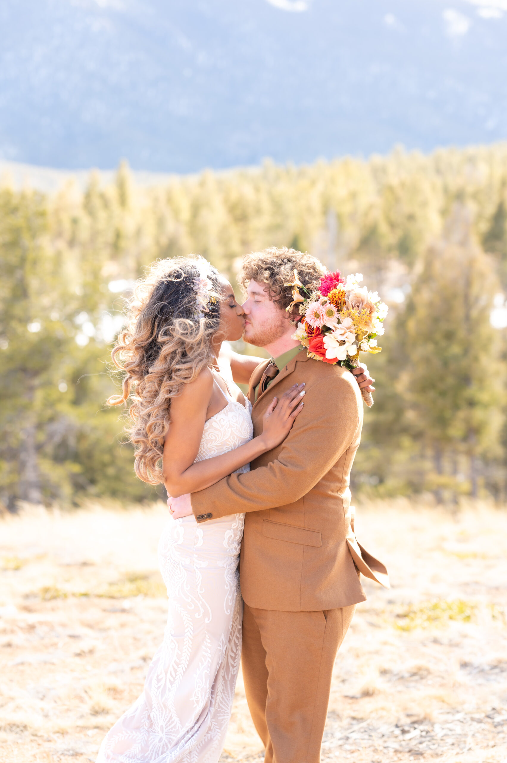 Bride and groom kissing in the mountains at pikes peak