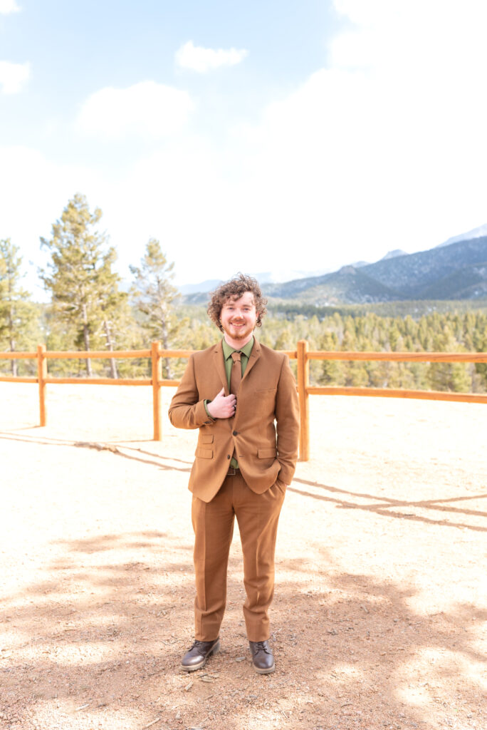 Portrait of the groom smiling at pikes peak mountain in Colorado Springs