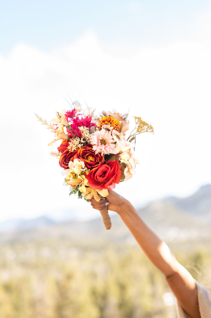 Bride holding up her flower bouquet on Colorado Springs elopement 