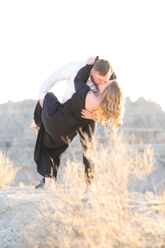 Groom giving his bride an intimate kiss on their elopement day at badlands national park