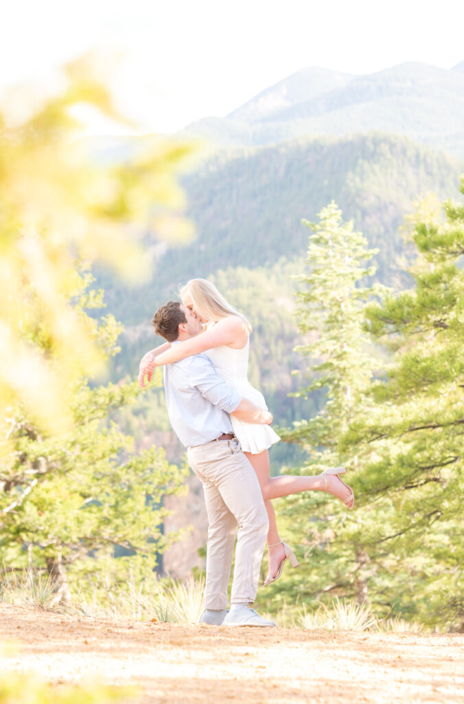 Groom picking up his bride in the mountains for their Colorado Springs Engagement Photoshoot
