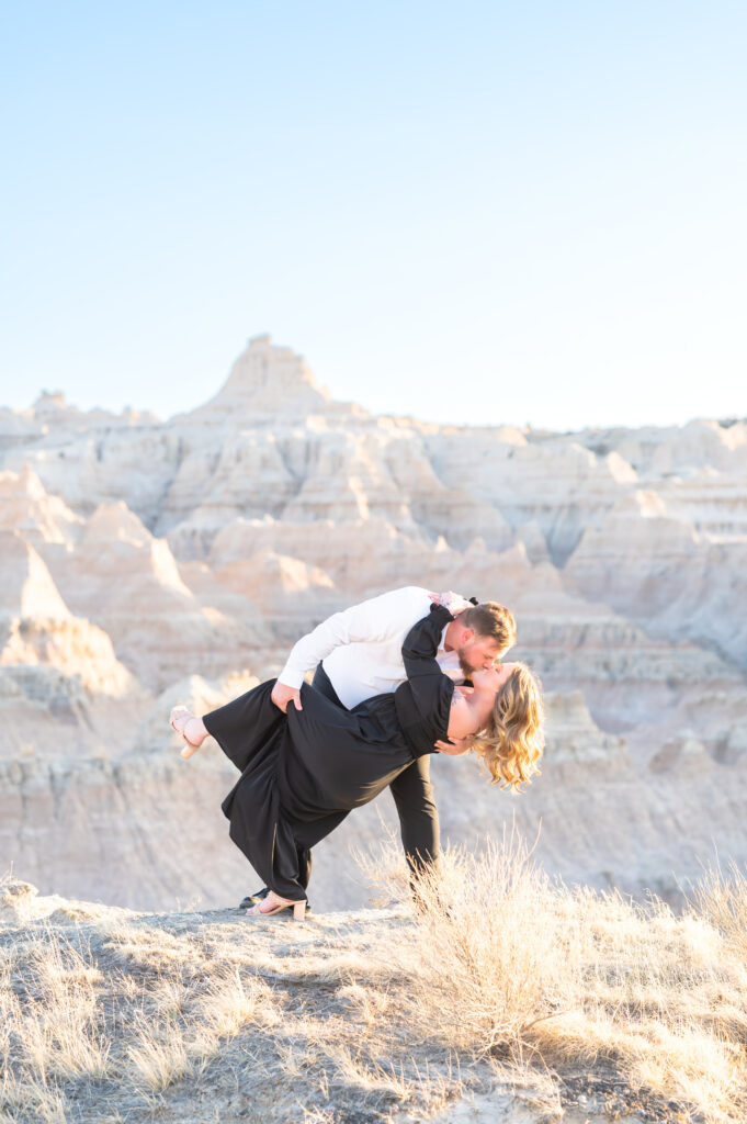 Groom dipping his bride for a kiss at badlands national park