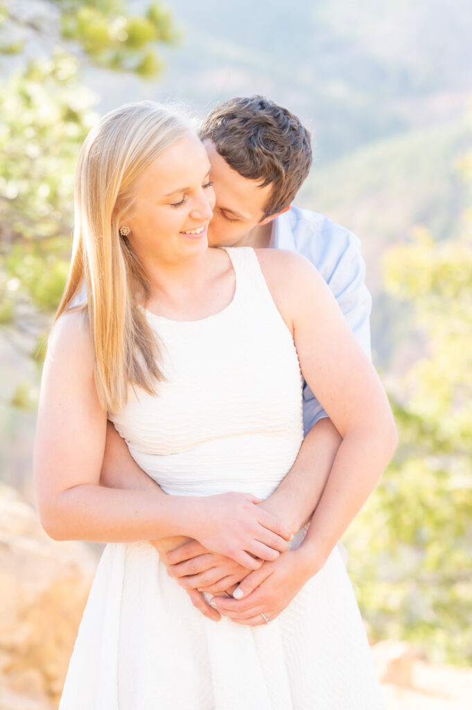 Groom caressing his bride on the cheek for an intimate portrait during their engagement photoshoot in Colorado Springs