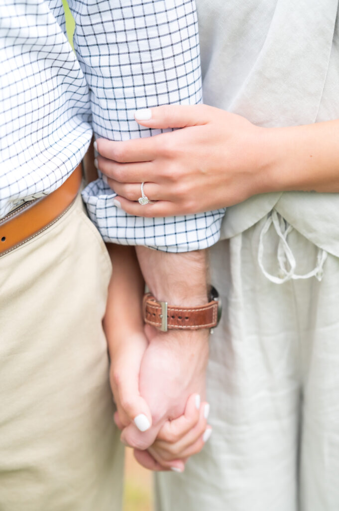 Close detailed ring shot of couple holding hands together 