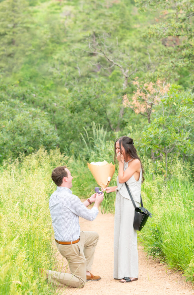 Carter getting down on one knee to proposal to his girlfriend at Cheyenne Mountain 