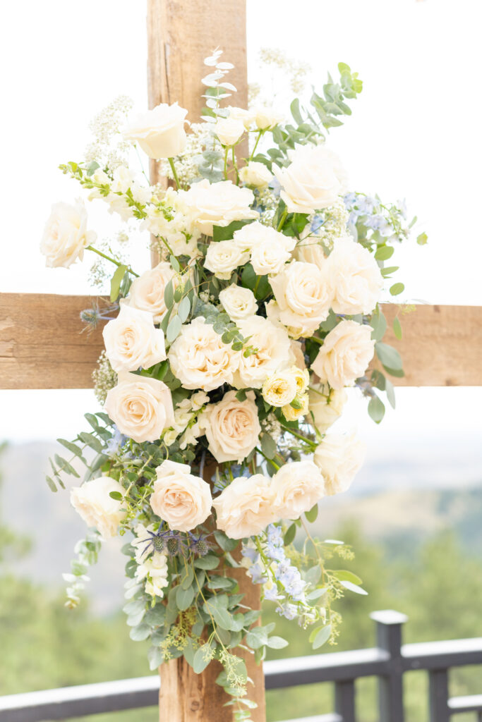 Bride's bouquet displayed on wooden fence post