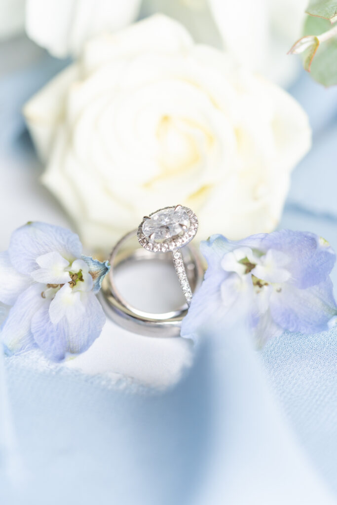 Detail of wedding ring and white rose showing what to expect when you book a wedding with Whitney Marshall Photo