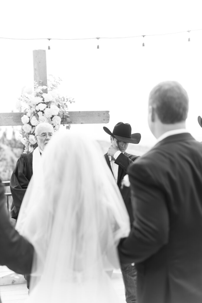 Groom getting emotional at the first look of his bride walking down the aisle towards him