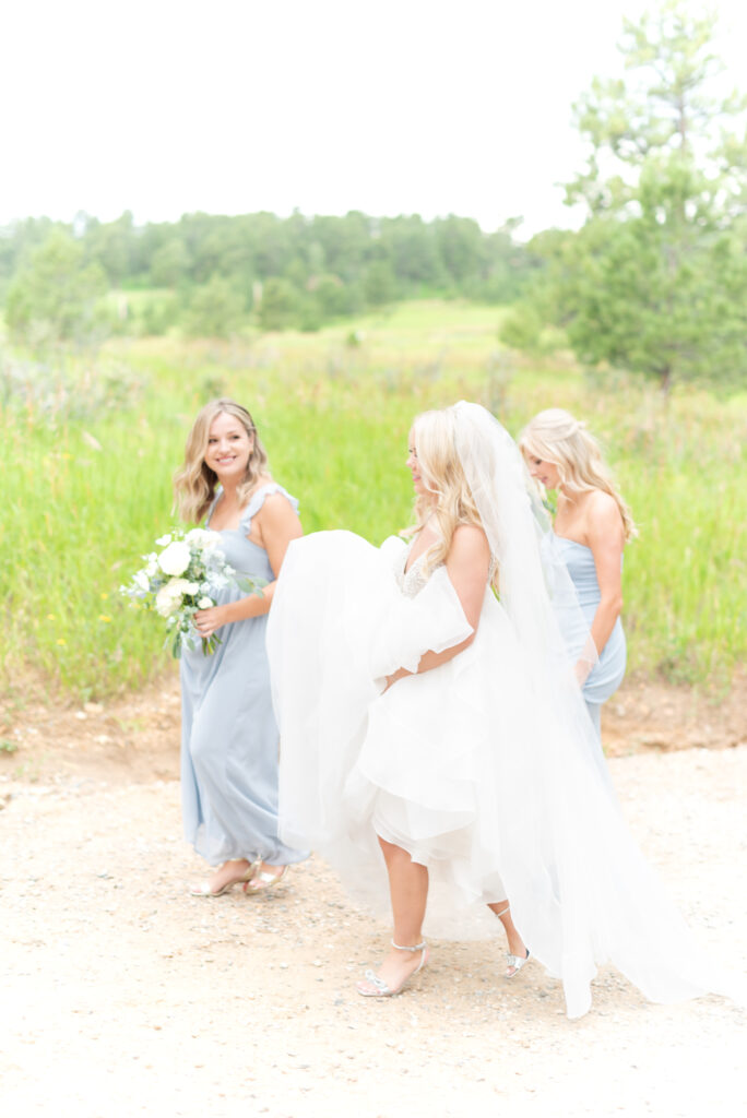 Bride walking along a trail with her bridesmaids at Mount Vernon Canyon Club 