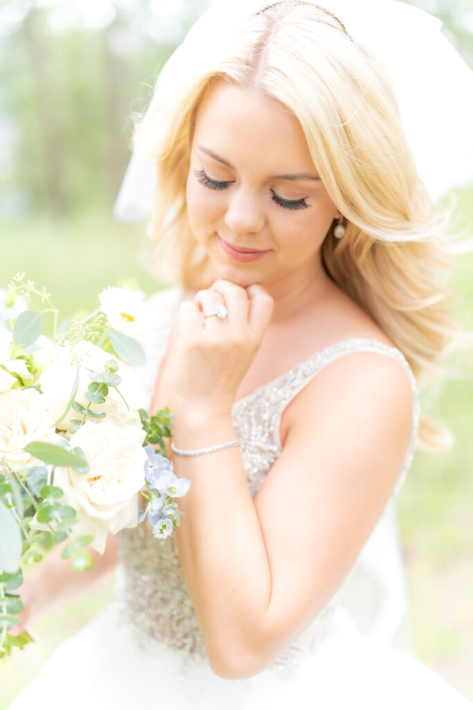 Wedding portrait of the bride holding her wrist up and holding her flower bouquet