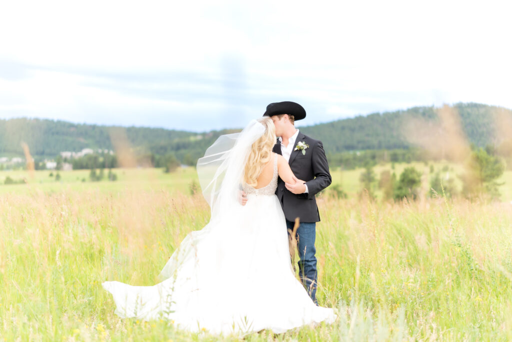 Bride and groom intimately hugging one another in an open field at Mount Vernon Canyon Club wedding venue