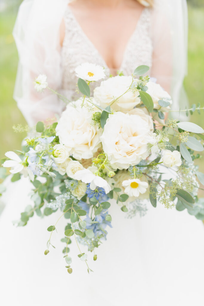 Bridal bouquet of white carnations and daisies with sprigs of forget-me-not and euchalyptus