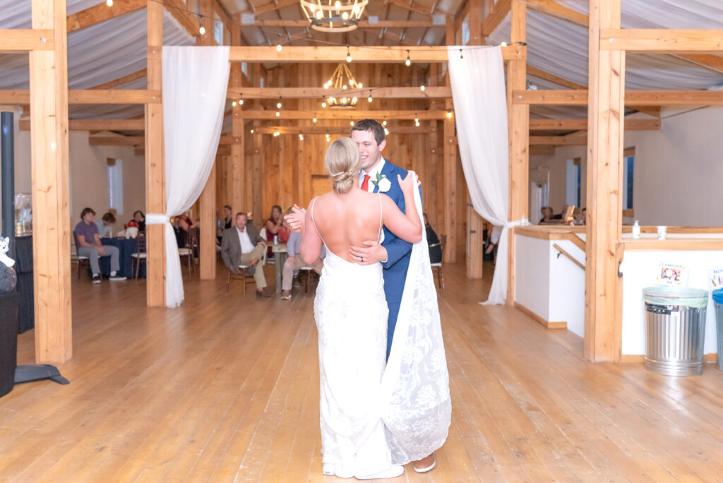 Bride and groom sharing their first dance together as husband and wife on the dance floor at Venetucci Farm Venue