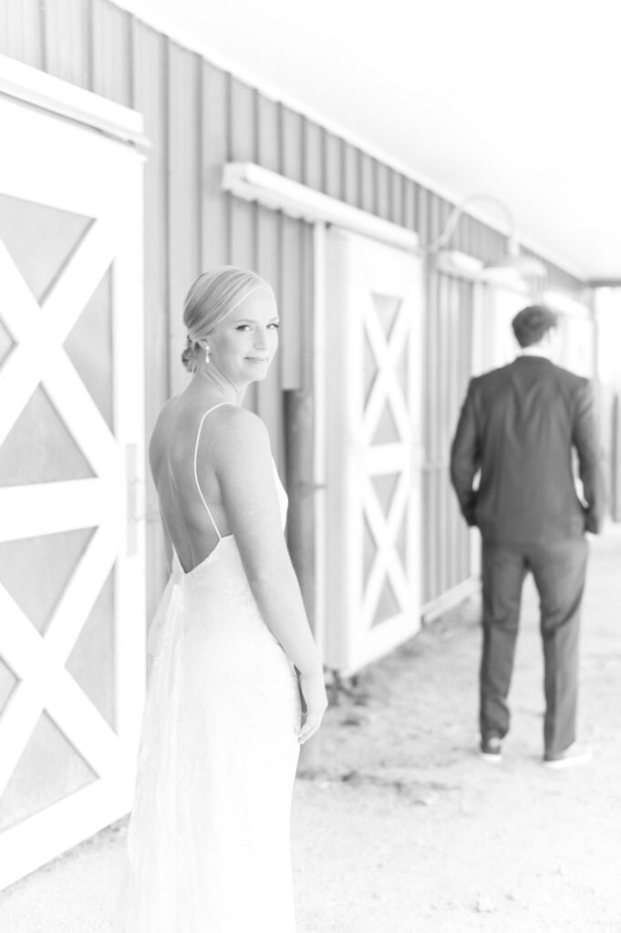 Bride looking back over her shoulder before her first look with her groom on their wedding day in Colorado Springs