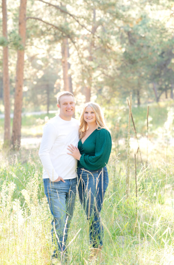 What to wear for your Colorado engagement session, woman in jeans and jewel-toned blouse, man in jeans and plain white shirt