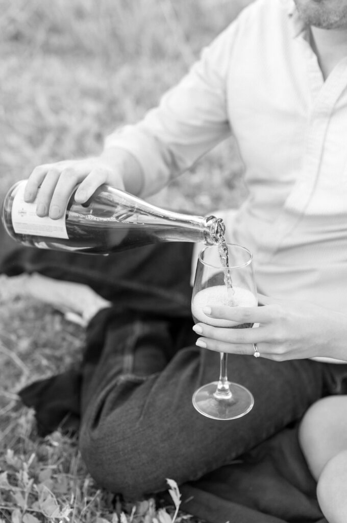 Couple pouring wine into their wine glass 