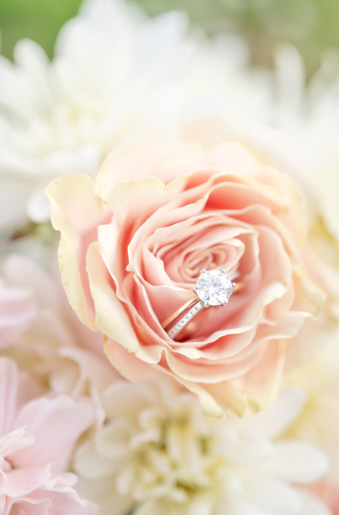 Detail photo of engagement ring sitting inside a pink flower