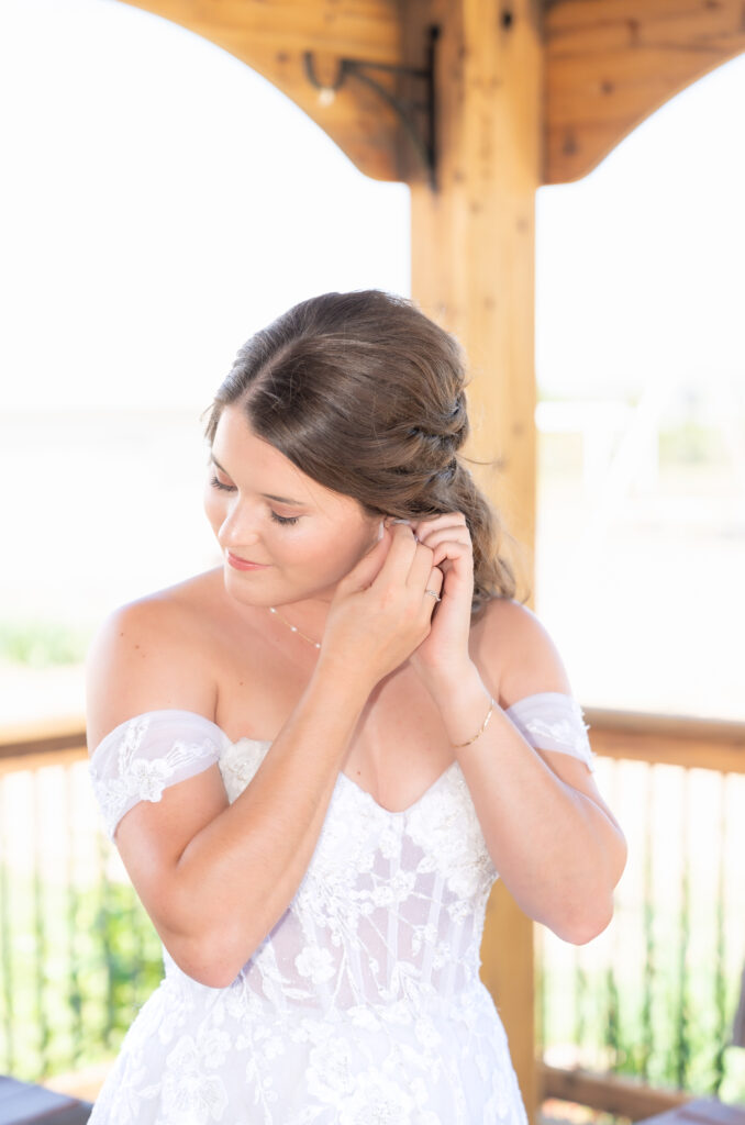 Bride putting on her earrings on her wedding day in Colorado