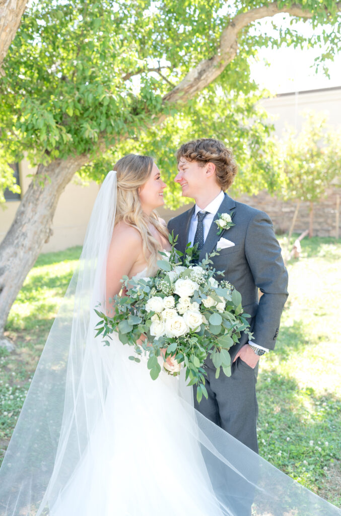 Bride and groom looking at each other smiling on their colorado wedding day at The Denver Inverness