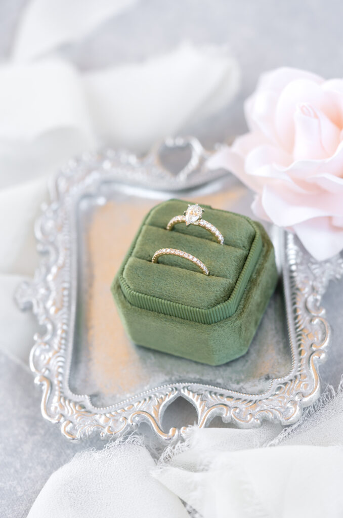 Wedding detail photo of brides ring in green velvet ring box