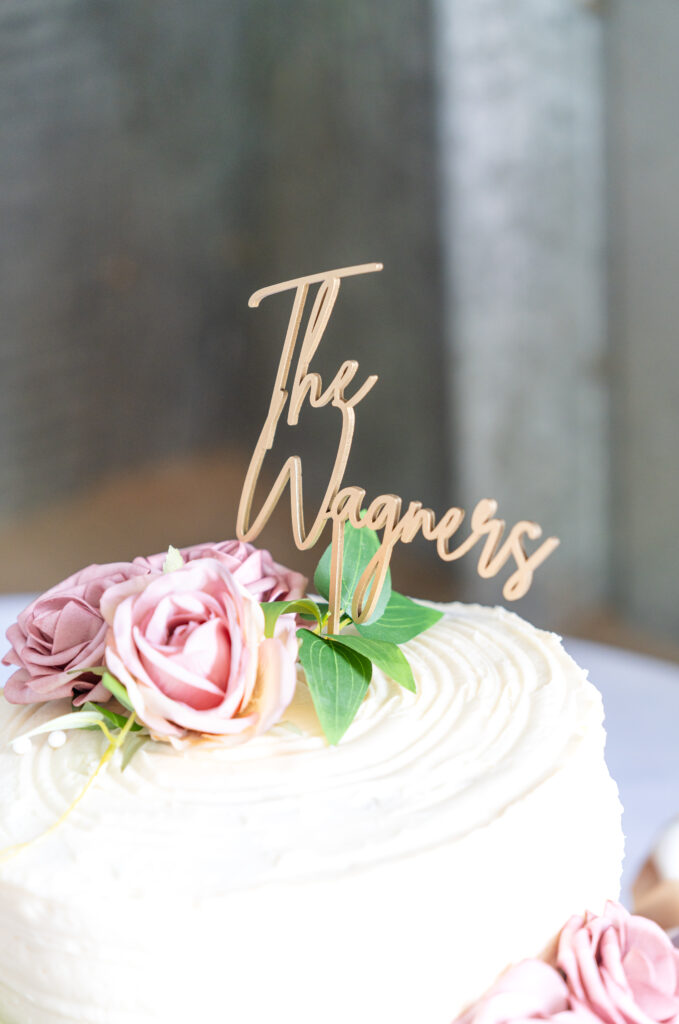 Detail photo of the wedding cake toper saying "The Wagners"