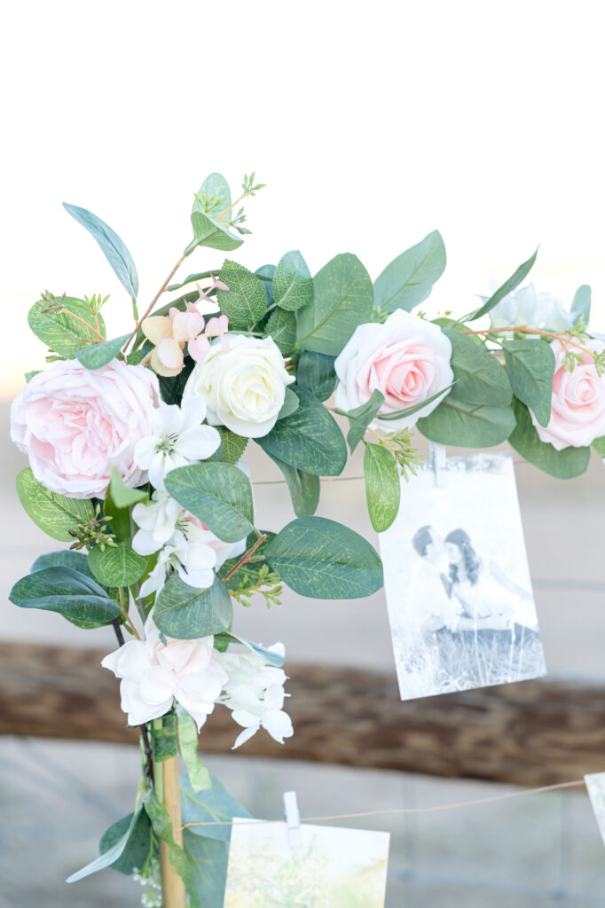 Detail photo of floral arrangement hanging on an picture frame arrangement 