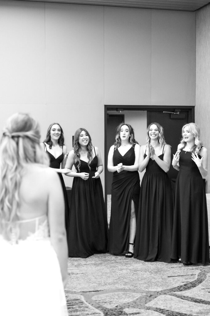 Bride sharing a first look with her bridesmaids on her Colorado wedding day at The Denver Inverness