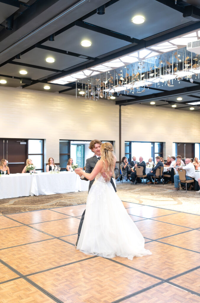 Bride and groom sharing their first dance together on the dance floor at The Denver Inverness in Colorado