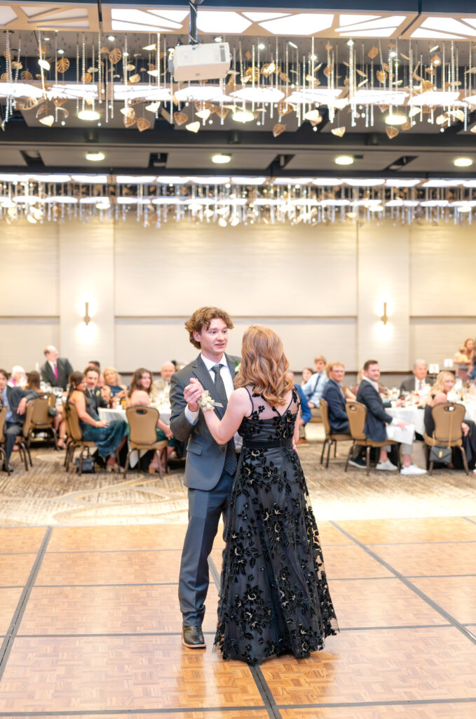 Groom sharing his first dance with his mom on the dance floor during wedding reception