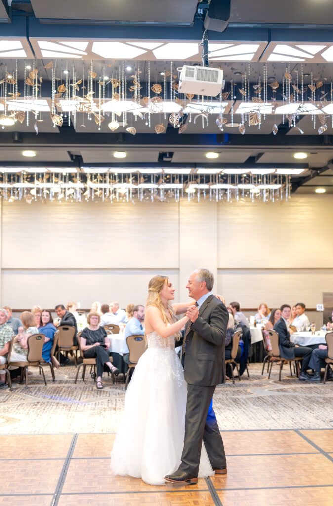 Bride sharing her first dance with her dado on the dance floor during wedding reception at The Denver Inverness