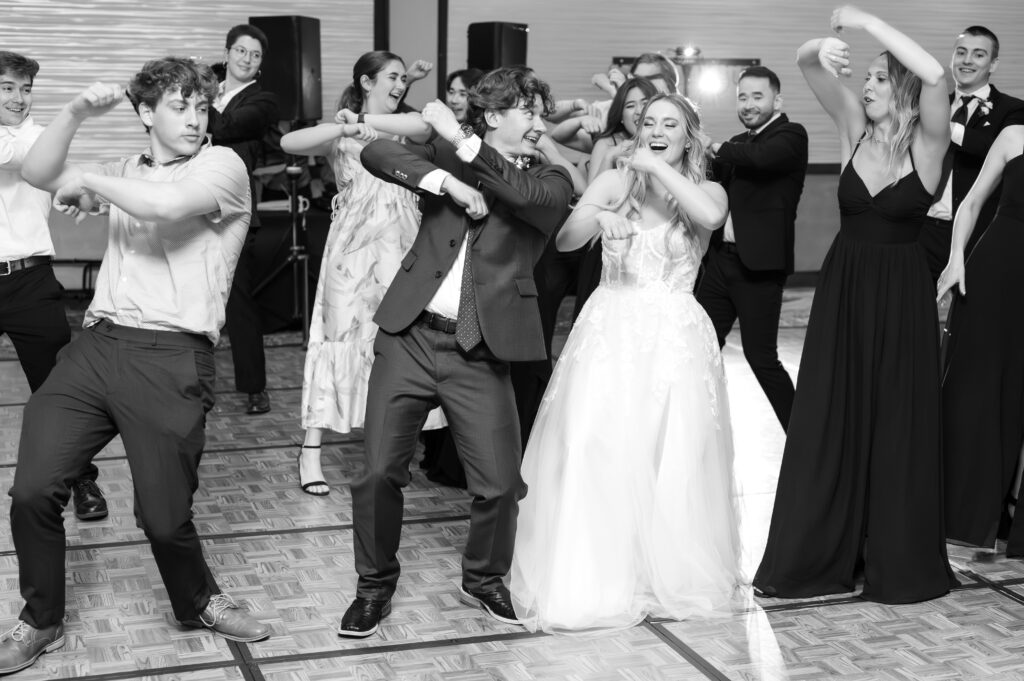 bride and groom dancing on the dance floor with their wedding guests at The Denver Inverness