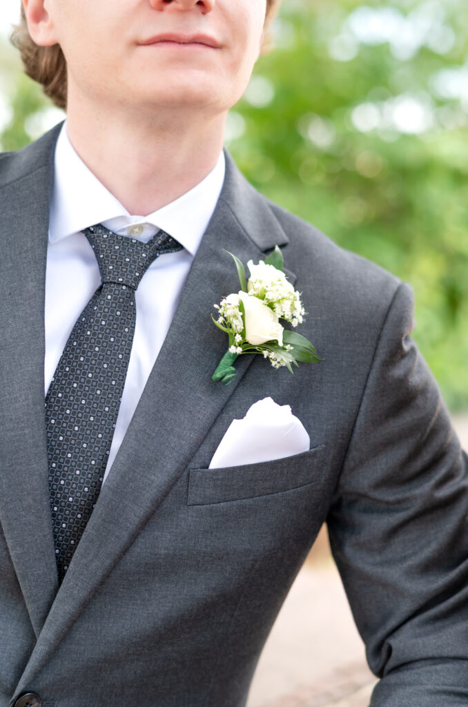 close detail photo of the groom's suit and his boutonniere during his wedding in Colorado