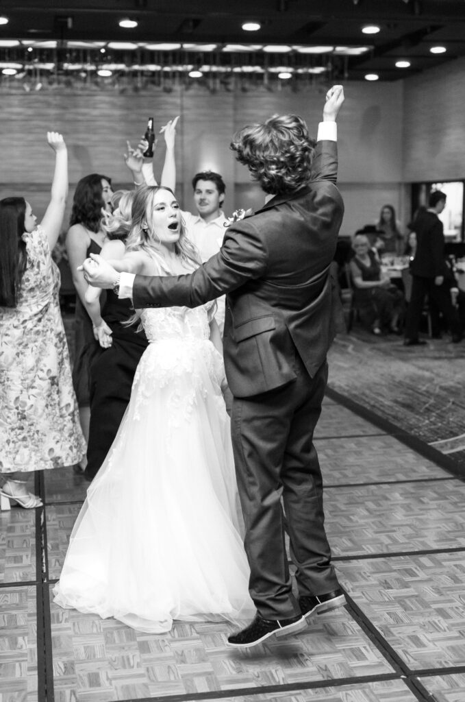 pictures of bride and groom dancing together holding hands on the dance floor during their Colorado wedding reception at The Denver Inverness 