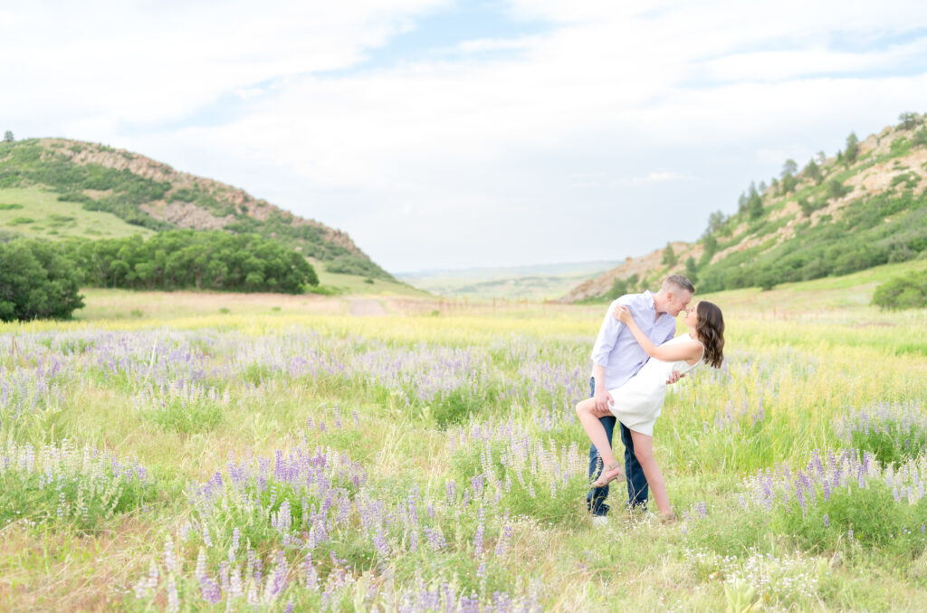 Couple sharing a romantic dip in mountain meadow field at Roxborough State Park