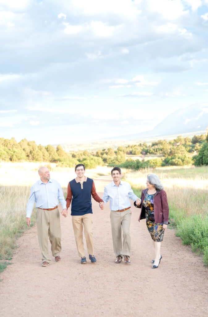 Style guide for classic and timeless family photos, older couple with their grown sons wearing muted fall colors during a family photoshoot in Colorado