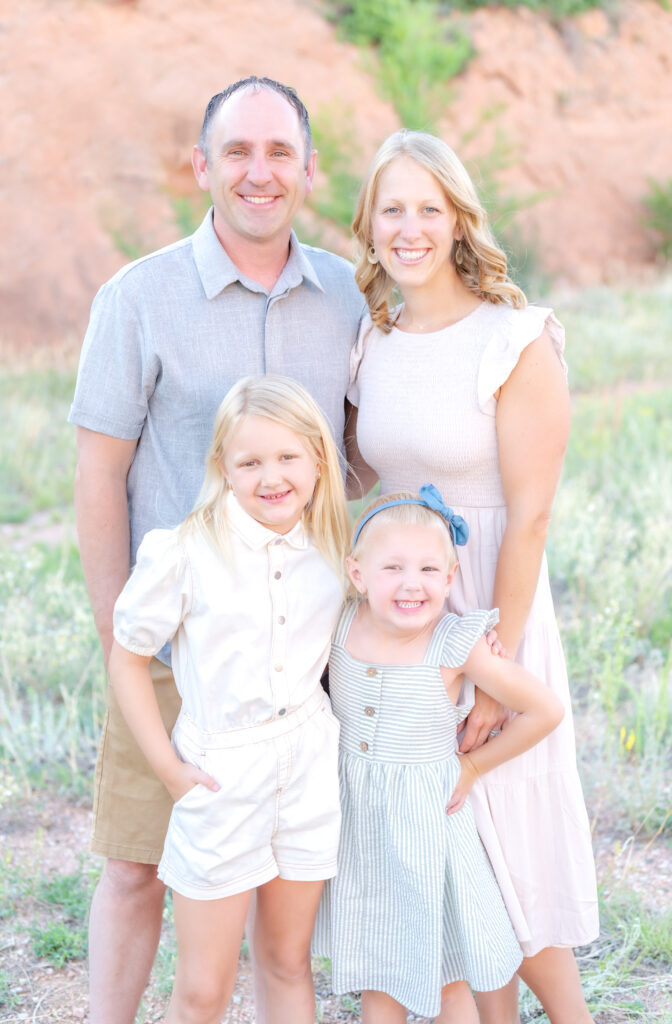 Parents with their two young daughters pose for family photos in Colorado Springs