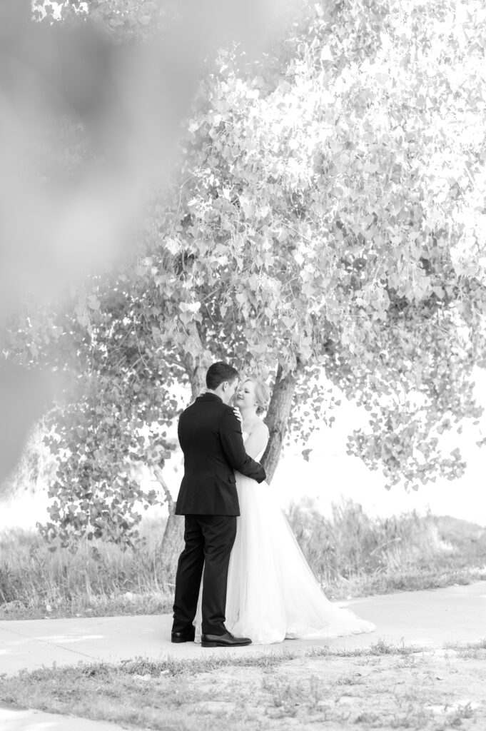 Bride and groom embracing for soft, intimate hug to share their first look moment on their wedding day 