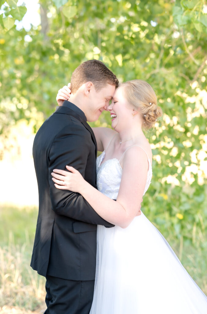 Bride and groom laughing together on their intimate Colorado Springs wedding day