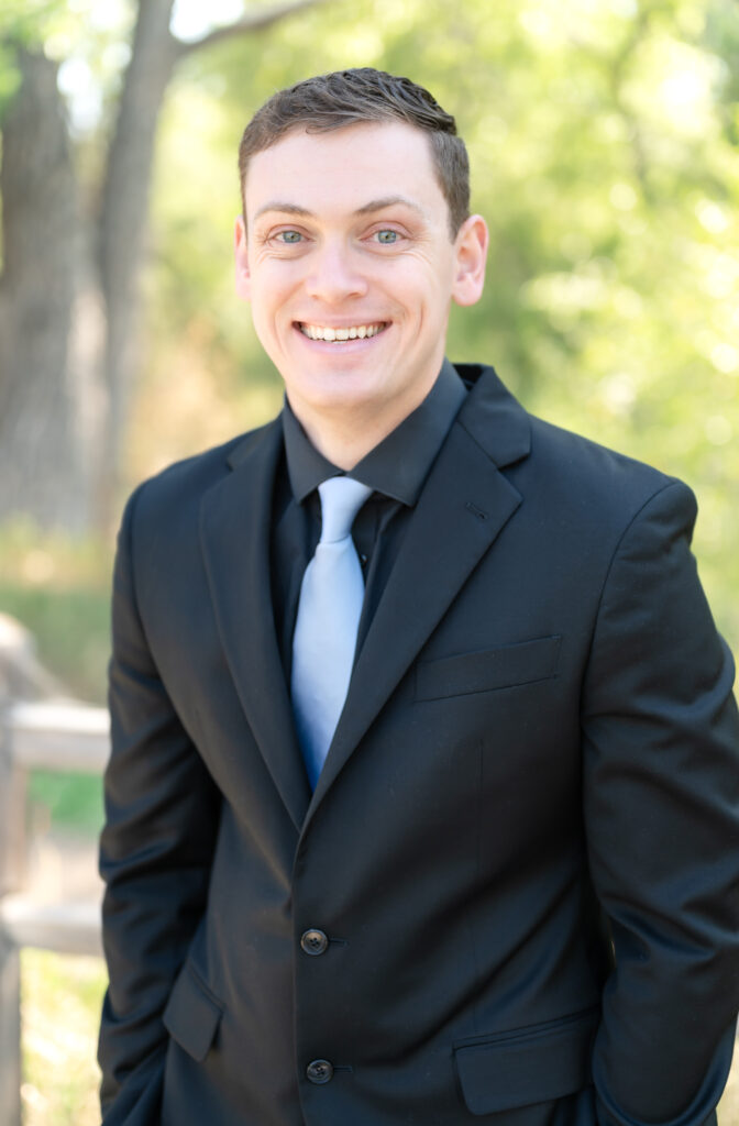 Groom standing and smiling towards camera for a portrait, intimate Colorado Springs wedding day