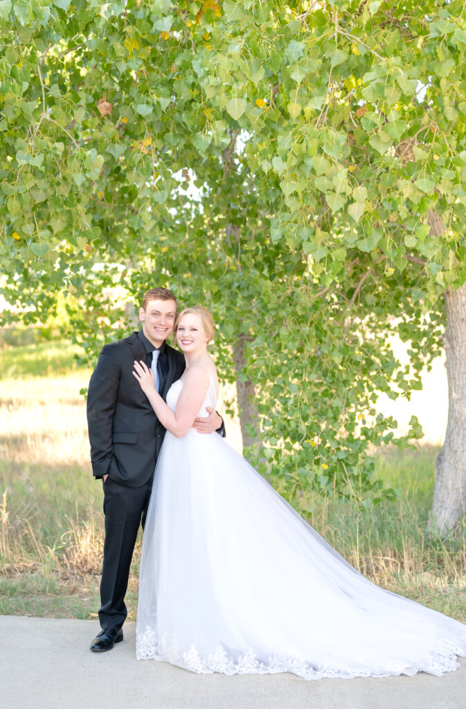 Bride and groom smiling at camera together on their intimate Colorado Springs wedding day