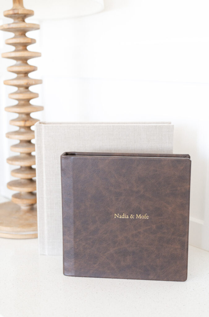 2 wedding albums, one bound in brown leather and the other in soft gray linen