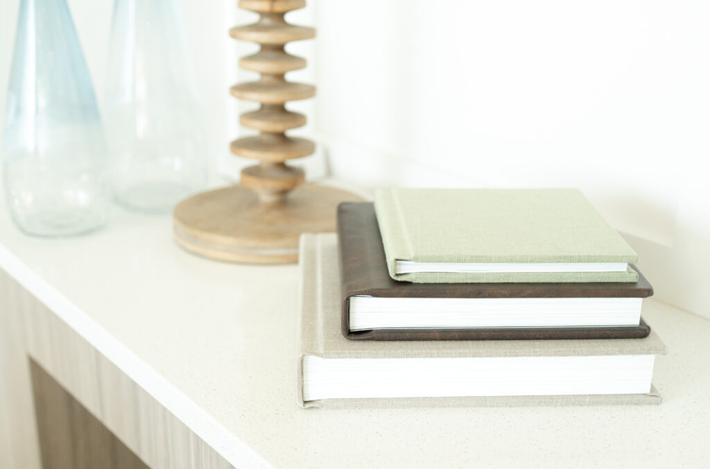 heirloom photo albums arranged on a mantelpiece in a living room in Colorado Springs