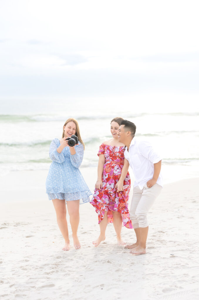 Colorado wedding photographer and engaged couple looking at photos together and laughing