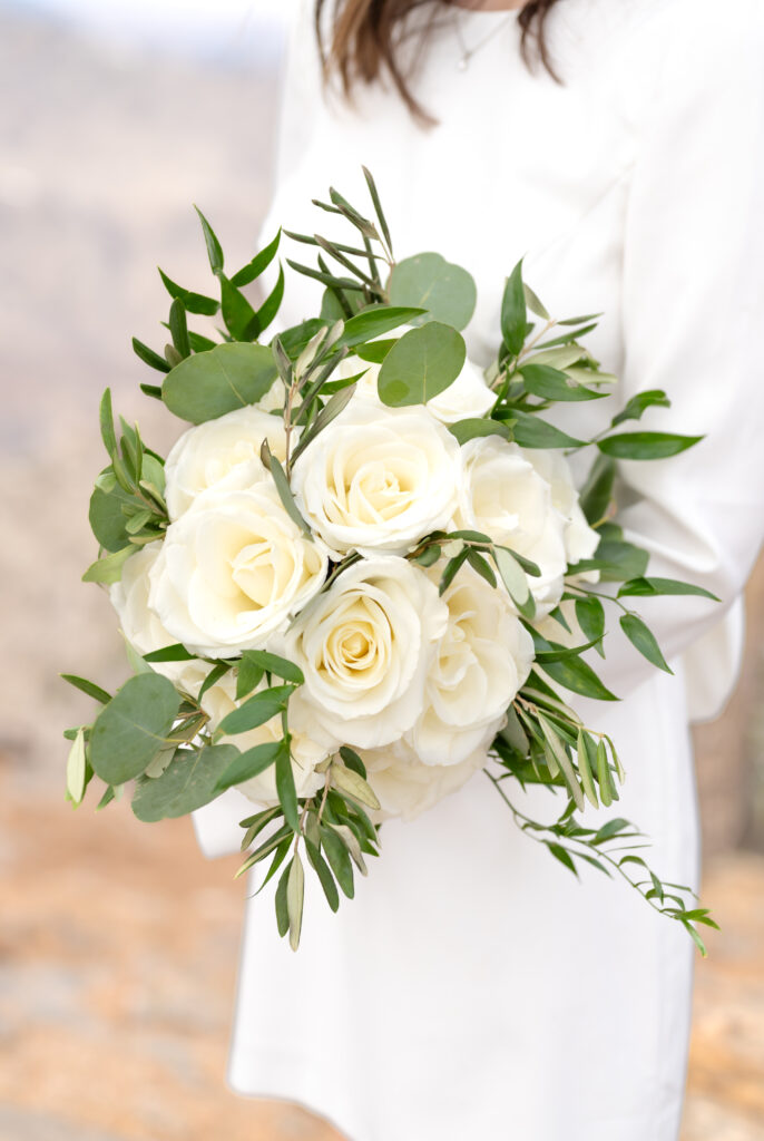 Closeup of the bride's white floral and greenery bridal bouquet