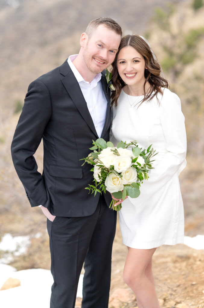 Bride and groom leaning their heads together as they smile towards the camera together for their couples portraits at Lookout Mountain